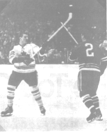 Stemkowski and Van Impe face off at center ice